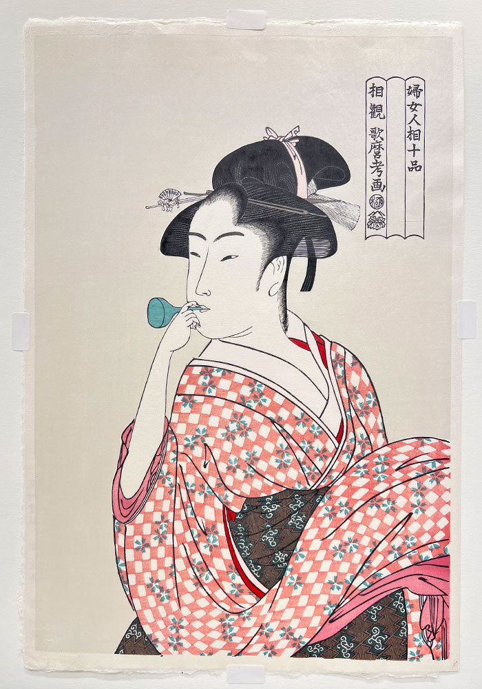 Woodblock print "Woman Playing a Poppin" by Utamaro Published by UNSODO